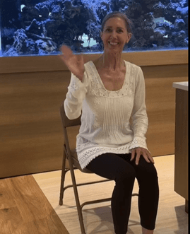 A person sitting in a chair
Description automatically generated